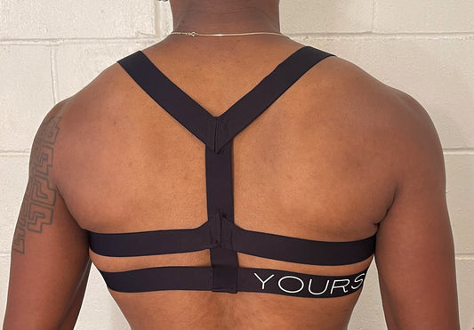 Man in chest harness, back view