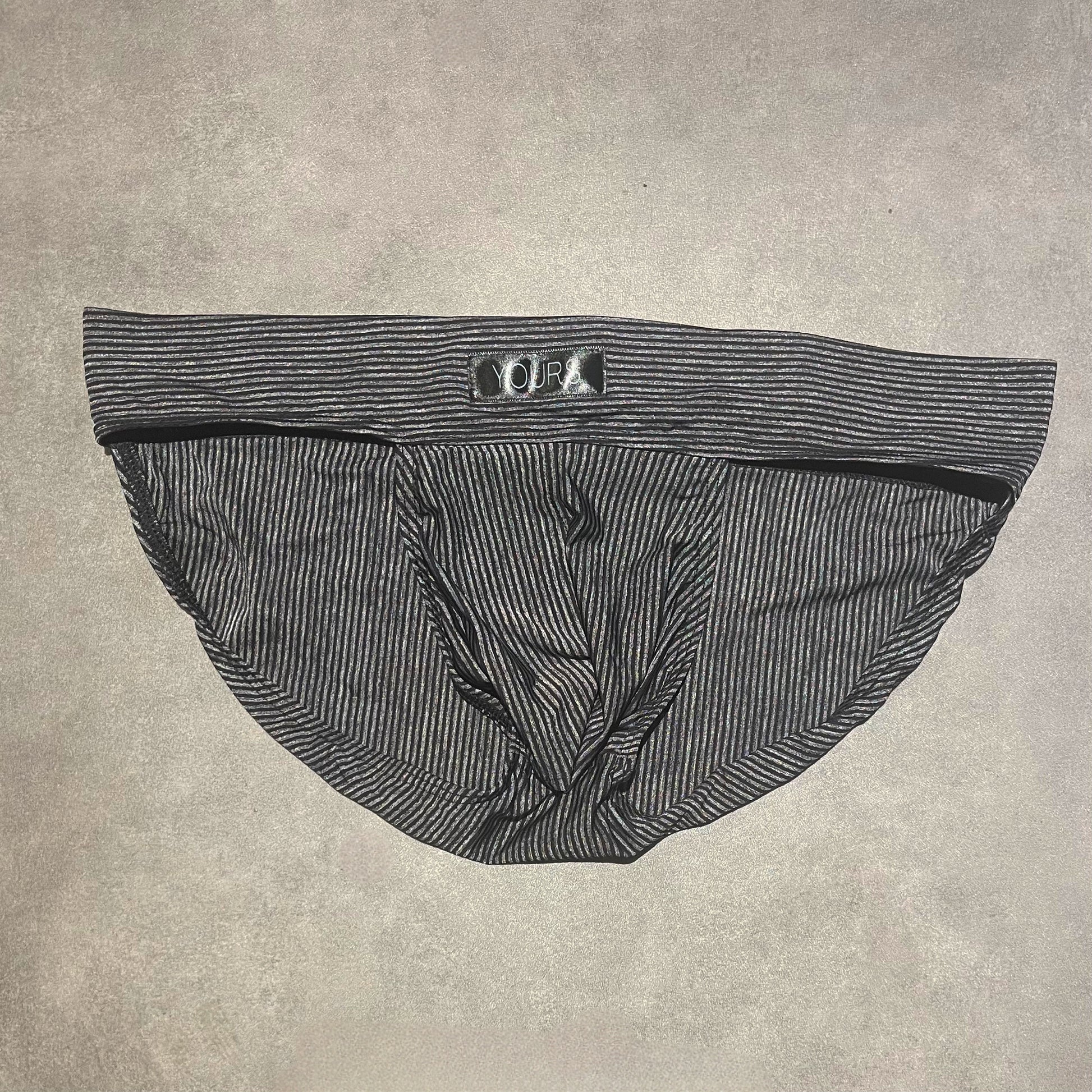 Flat lay photo of black striped briefs