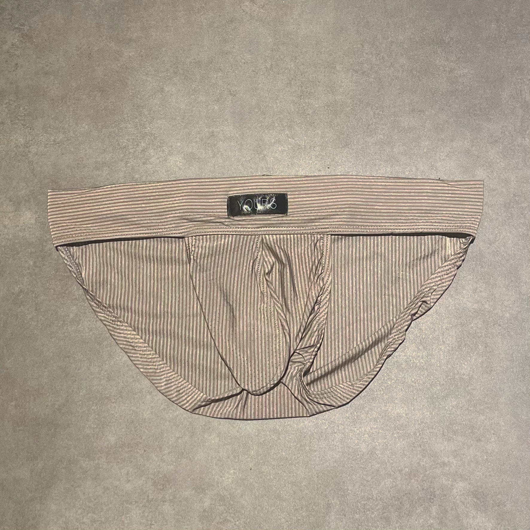 Flat lay photo of stone colored striped briefs