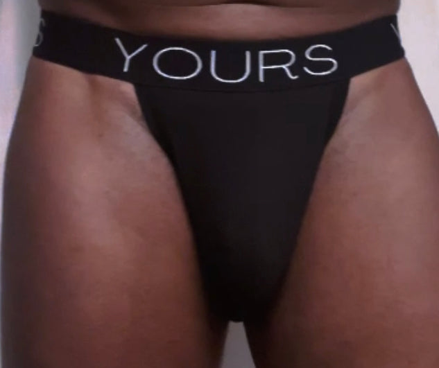 Man in black tanga underwear, forward facing 