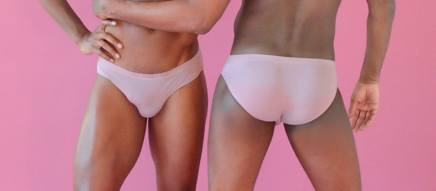 2 men in a pale colored cotton brief underwear, one forward and one backward